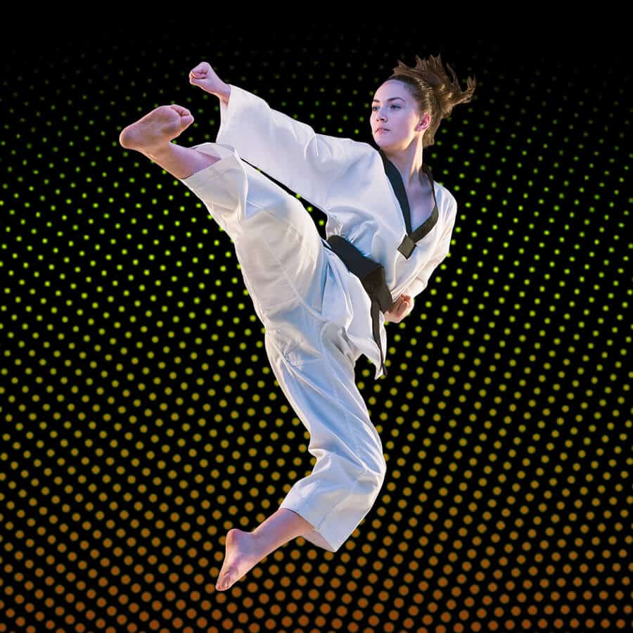 Martial Arts Lessons for Adults in Strongville OH - Girl Black Belt Jumping High Kick